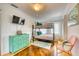 bedroom featuring a black bunk bed with colorful patterned bedding, hardwood floors and bright decor at 76 S Washington Dr, Sarasota, FL 34236