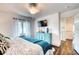 Cozy bedroom featuring hardwood floors, blue dresser, and natural light at 76 S Washington Dr, Sarasota, FL 34236