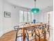 Bright dining room features hardwood floors, pendant lighting, and a table set for six at 76 S Washington Dr, Sarasota, FL 34236