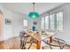 Spacious dining room with hardwood floors, large windows, and a striking turquoise pendant lamp at 76 S Washington Dr, Sarasota, FL 34236