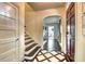 Inviting foyer features decorative tile flooring, a staircase, and natural light at 76 S Washington Dr, Sarasota, FL 34236