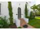Elegant front entrance with brick steps, manicured greenery, and a classic wooden door, offering a welcoming curb appeal at 76 S Washington Dr, Sarasota, FL 34236
