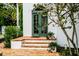 Charming front entrance featuring brick steps and a green door at 76 S Washington Dr, Sarasota, FL 34236