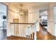 Upstairs hallway featuring hardwood floors, leading to bedrooms and other areas at 76 S Washington Dr, Sarasota, FL 34236