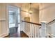Hallway with hardwood floors leading to the bathroom and other areas of the home at 76 S Washington Dr, Sarasota, FL 34236