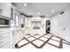 Modern kitchen featuring custom cabinetry, high-end appliances, and stylish tile flooring at 76 S Washington Dr, Sarasota, FL 34236