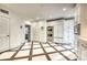 Bright kitchen showcasing stainless steel appliances, custom cabinets and decorative floor tiles at 76 S Washington Dr, Sarasota, FL 34236