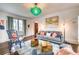 Inviting living room with hardwood floors, a plush gray sofa and striking, modern decor at 76 S Washington Dr, Sarasota, FL 34236