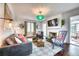 Inviting living room with designer furnishings, a decorative fireplace, and large windows with bright natural light at 76 S Washington Dr, Sarasota, FL 34236
