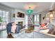 Bright living room with modern decor, fireplace, and hardwood floors with large windows providing ample natural light at 76 S Washington Dr, Sarasota, FL 34236