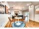 Open-concept living room and dining area featuring hardwood floors, neutral walls and large windows providing lots of natural light at 76 S Washington Dr, Sarasota, FL 34236