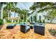 Outdoor seating area with brick patio and lush landscaping at 76 S Washington Dr, Sarasota, FL 34236