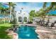 Beautiful pool area with brick patio, fountain, and lush landscaping at 76 S Washington Dr, Sarasota, FL 34236