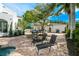 Inviting pool area featuring brick patio, lounge chairs, and well manicured landscaping at 76 S Washington Dr, Sarasota, FL 34236