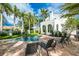 Relaxing pool area with lush landscaping, brick patio, and comfortable lounge chairs at 76 S Washington Dr, Sarasota, FL 34236