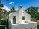 Charming rooftop deck with stucco walls, seating, and a peek at the surrounding tropical landscape offering a relaxing outdoor space at 76 S Washington Dr, Sarasota, FL 34236