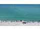 Beautiful aerial view of a beach with tourists and a boat advertising tours at 777 Beach Rd # 1B, Sarasota, FL 34242