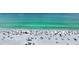 Bustling beach with turquoise water and lots of beachgoers under colorful umbrellas at 777 Beach Rd # 1B, Sarasota, FL 34242