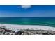 Scenic aerial view of a white sand beach and turquoise ocean under a clear blue sky at 777 Beach Rd # 1B, Sarasota, FL 34242