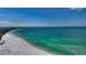 Wide angle aerial view of the sandy beach along the turquoise waters at 777 Beach Rd # 1B, Sarasota, FL 34242
