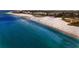 Beautiful beach view with clear blue water and white sand near the building at 777 Beach Rd # 1B, Sarasota, FL 34242