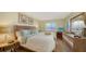 Relaxing bedroom with wooden furnishings, a window with blinds, and tasteful decorative accents at 777 Beach Rd # 1B, Sarasota, FL 34242
