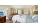 Comfortable bedroom featuring soft, natural light, a dresser with mirror, and simple, clean decor at 777 Beach Rd # 1B, Sarasota, FL 34242