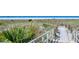 Boardwalk leading to Siesta Beach with white sand and clear blue water at 777 Beach Rd # 1B, Sarasota, FL 34242