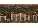 Condo building with large windows and balconies surrounded by lush tropical landscaping and city views at 777 Beach Rd # 1B, Sarasota, FL 34242