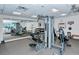 Equipped gym with modern machines, free weights, mirrored walls, and natural light for a complete workout experience at 777 Beach Rd # 1B, Sarasota, FL 34242