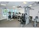 Well-equipped gym featuring treadmills, ellipticals, and weight machines with views of the outdoor pool area at 777 Beach Rd # 1B, Sarasota, FL 34242