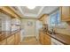 Functional kitchen featuring essential appliances, wooden cabinetry, and light countertops at 777 Beach Rd # 1B, Sarasota, FL 34242