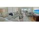 Open living room with comfortable blue sofas and a view of the outdoor patio at 777 Beach Rd # 1B, Sarasota, FL 34242