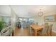 Open living space with dining area, comfortable seating, and access to outdoor patio at 777 Beach Rd # 1B, Sarasota, FL 34242