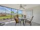 Bright patio with glass table, four chairs, and a view of the beach parking area at 777 Beach Rd # 1B, Sarasota, FL 34242
