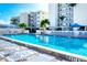 Relax by the pool with its clear blue water and plenty of lounge chairs surrounded by well-maintained landscaping at 777 Beach Rd # 1B, Sarasota, FL 34242