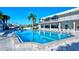 Enjoy this beautiful outdoor pool with sun loungers and clear blue umbrellas for shade on sunny days at 777 Beach Rd # 1B, Sarasota, FL 34242