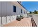 Side balcony includes two dark green chairs, with views of the neighborhood and blue skies above at 803 Gladiolus St, Anna Maria, FL 34216