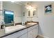 Bright bathroom features double sinks with white cabinetry and framed mirrors at 803 Gladiolus St, Anna Maria, FL 34216