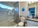 Bathroom featuring a glass enclosed shower with river rock floor and gray tiling at 803 Gladiolus St, Anna Maria, FL 34216