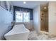 Luxurious bathroom featuring a freestanding tub, walk-in shower, and stylish tile accents at 803 Gladiolus St, Anna Maria, FL 34216