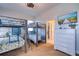 Bright bedroom featuring two bunkbeds, hardwood floors, ceiling fan, and large dresser with television at 803 Gladiolus St, Anna Maria, FL 34216