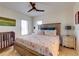 Comfortable bedroom with wood-look floors, ceiling fan, and a crib at 803 Gladiolus St, Anna Maria, FL 34216