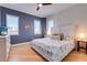 Comfortable bedroom featuring hardwood floors, three windows, and light paint at 803 Gladiolus St, Anna Maria, FL 34216