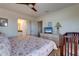 Bedroom with wood-look floors, ceiling fan, and ensuite bath at 803 Gladiolus St, Anna Maria, FL 34216
