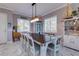 Dining room with a large table, bright lighting, and beach decor elements at 803 Gladiolus St, Anna Maria, FL 34216
