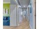 Bright hallway with beautiful hardwood floors, crown molding and access to multiple rooms at 803 Gladiolus St, Anna Maria, FL 34216