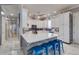 Well-lit kitchen features a spacious island with seating, white cabinets, and modern appliances at 803 Gladiolus St, Anna Maria, FL 34216