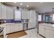 Modern kitchen with white cabinets, stainless steel appliances, and a tile backsplash at 803 Gladiolus St, Anna Maria, FL 34216