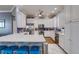 Bright kitchen with stainless steel appliances, a spacious island with seating, and white cabinets at 803 Gladiolus St, Anna Maria, FL 34216